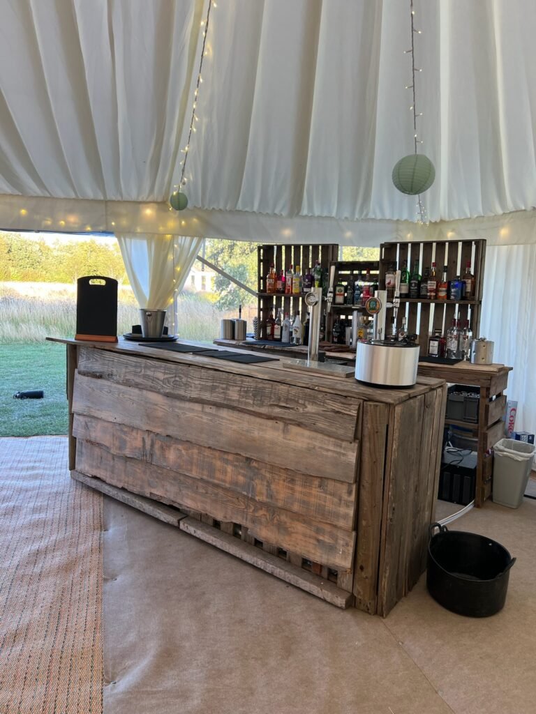 Raise the Bar rustic wooden mobile bar set up inside a marquee