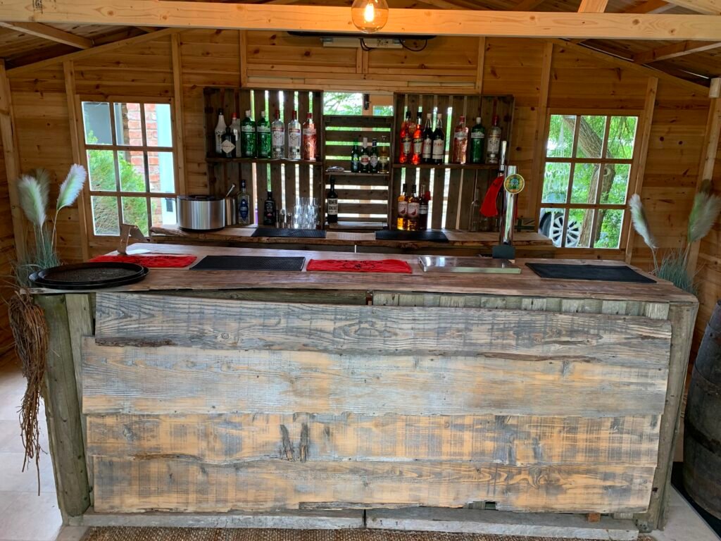 Raise the Bar rustic wooden mobile bar inside a wooden venue